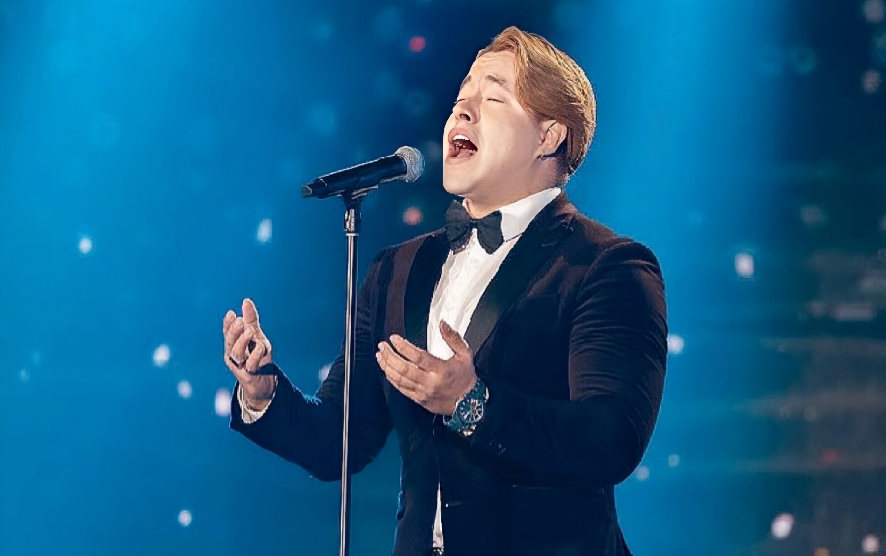 David Capiello performing on stage in formal attire