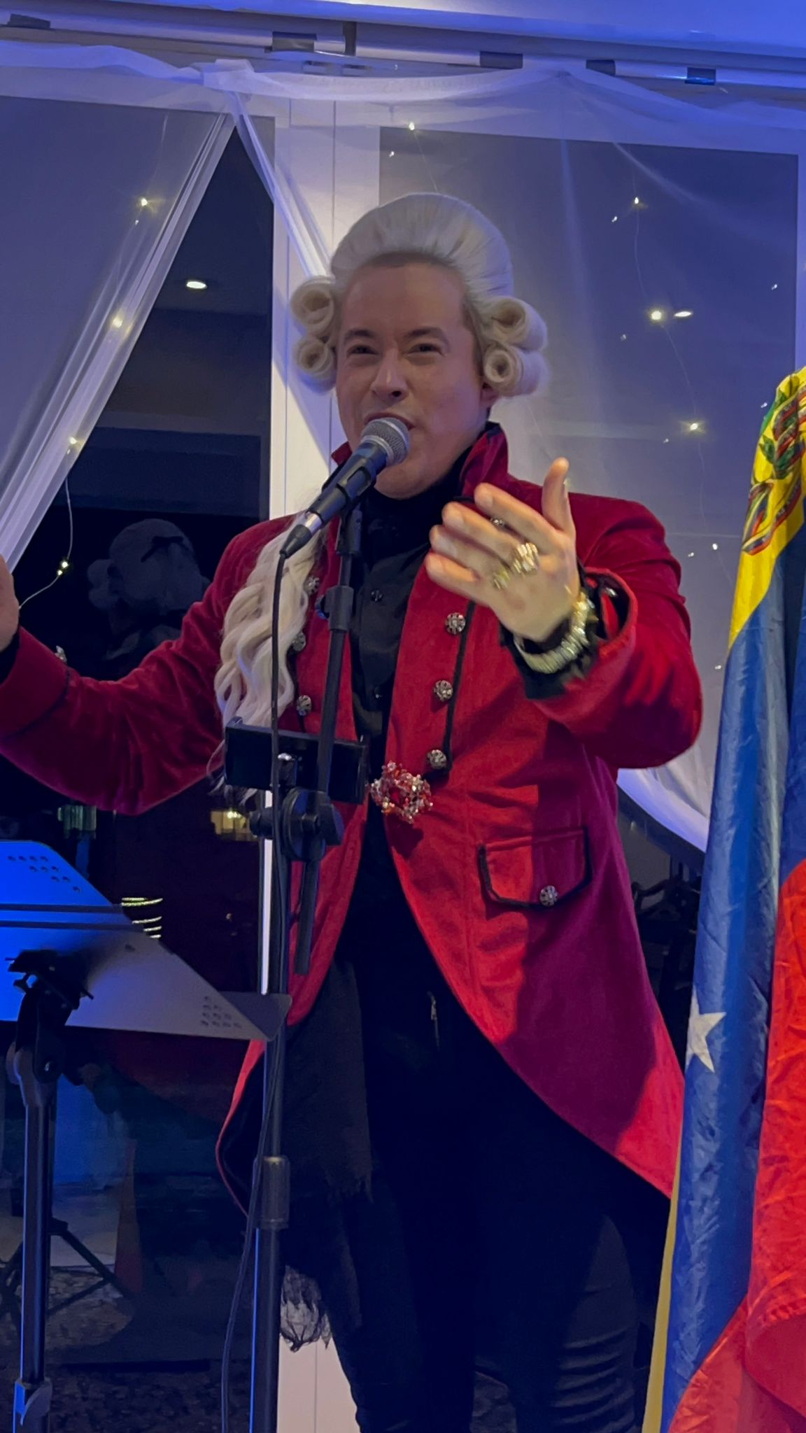 David Capiello performing at the mic in Victorian costume